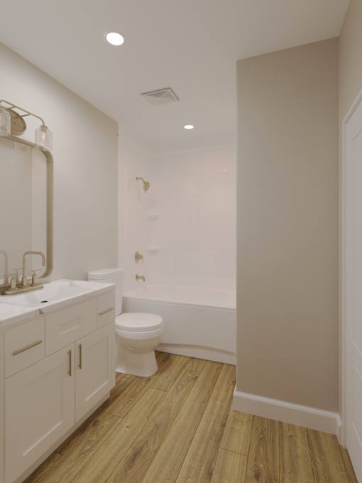 A white bathroom with wood flooring and a toilet.