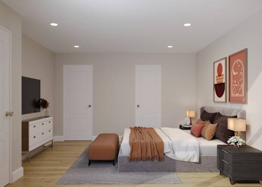 A bedroom with a large bed and a dresser with a mirror.