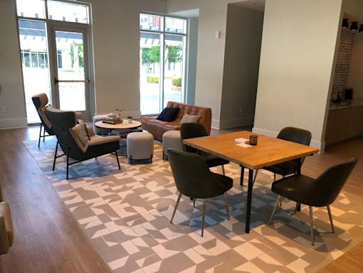 A living room with a table and chairs.