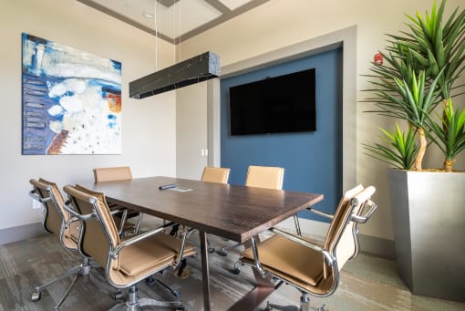 a conference room with a table and chairs