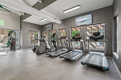 A gym with treadmills, elliptical machines, and other cardio equipment.