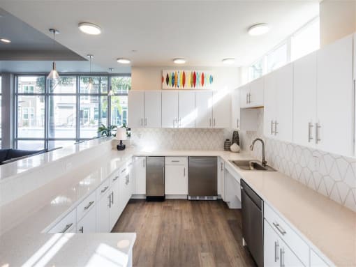 a large white kitchen with white cabinets and a sink