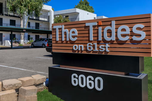 a sign for the tides on 651 in front of a building