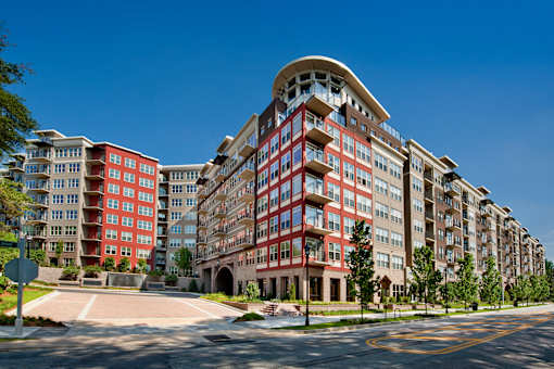 A large red and beige apartment building with a curved top.