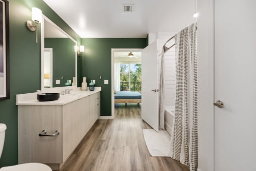 a bathroom with green walls and a shower and a sink