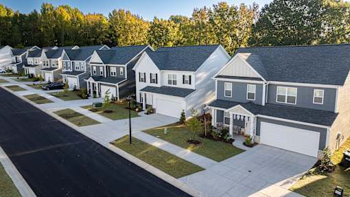 A row of houses with a street in front.