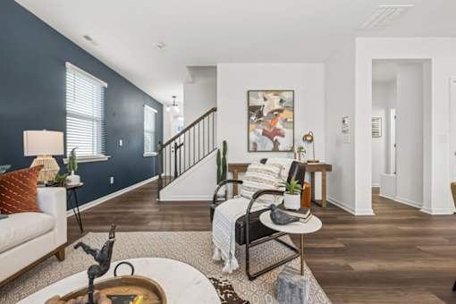 A living room with a white couch, a chair, and a coffee table.
