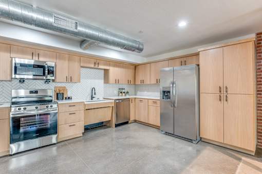 A kitchen with wooden cabinets and stainless steel appliances.
