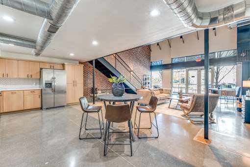 A modern open plan kitchen and dining area with a staircase.