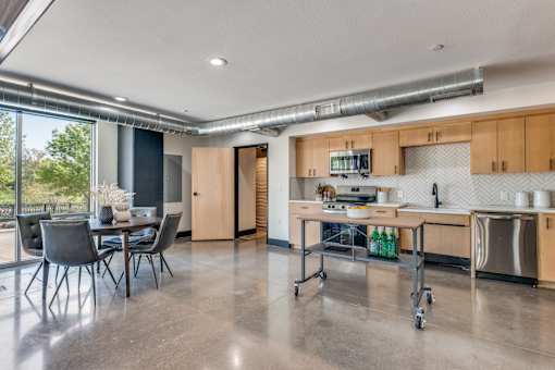A modern kitchen with a dining table and chairs.