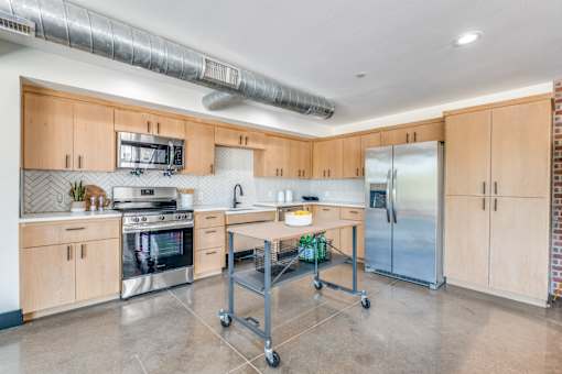 A kitchen with wooden cabinets and stainless steel appliances.