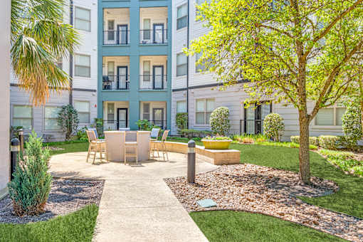 A modern apartment complex with a well-maintained courtyard.