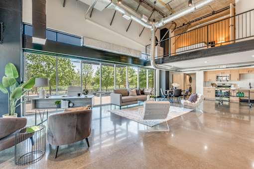 A modern open plan office with a balcony and lots of natural light.