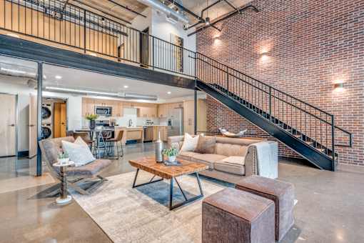 A living room with a couch, chairs, and a coffee table.