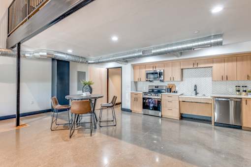 A modern kitchen with a dining table and chairs.