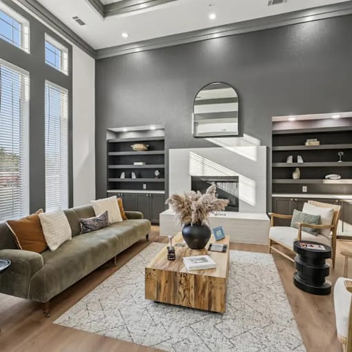 A modern living room with a green sofa and a wooden coffee table.