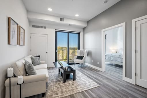 A modern living room with a large window and a view of the outdoors.