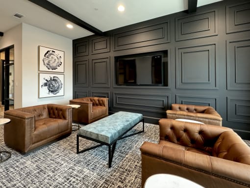 a living room with leather couches and a tv