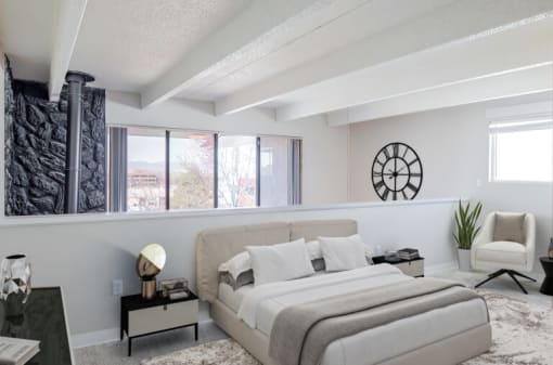 a bedroom with a bed and a large window