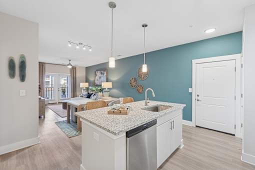 A kitchen with a large island and a sink.