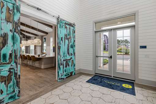 A room with a blue mat on the floor and a glass door.