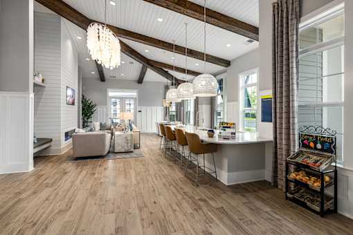 A modern kitchen with a dining area and a living room.