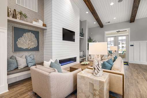 A living room with a couch, a chair, a table, and a painting on the wall.