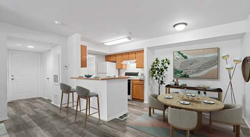 A modern kitchen with a dining table set for four.