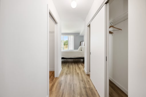 a bedroom with white walls and white doors and a bed