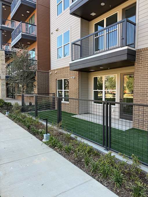 A building with a balcony and a fence.