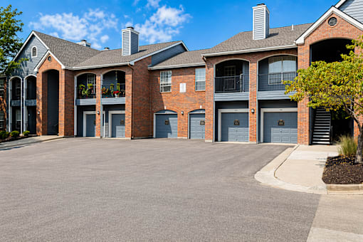A large brick building with multiple garage doors.
