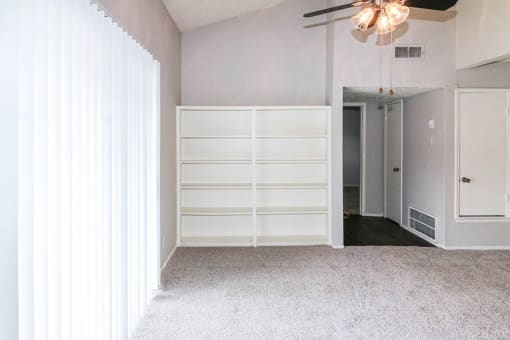 a room with white walls and white furniture and a white door
