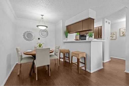 A dining room with a table set for four.