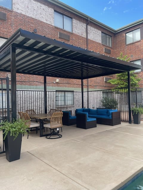 a patio with a table and chairs under awning