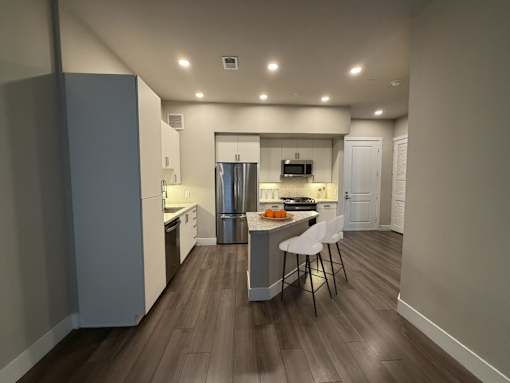A kitchen with a table and chairs in the middle of the room.