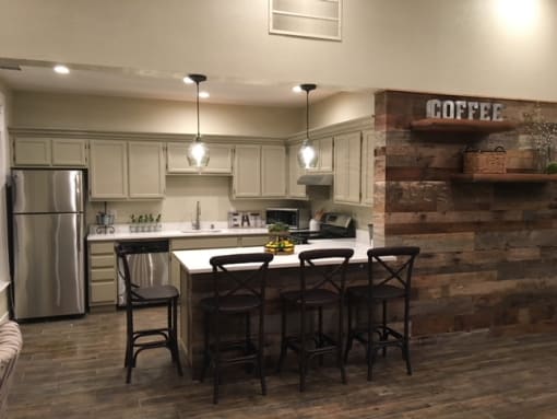 a kitchen with a bar and a table with chairs
