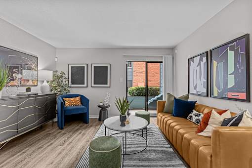 A living room with a blue chair and a brown couch.