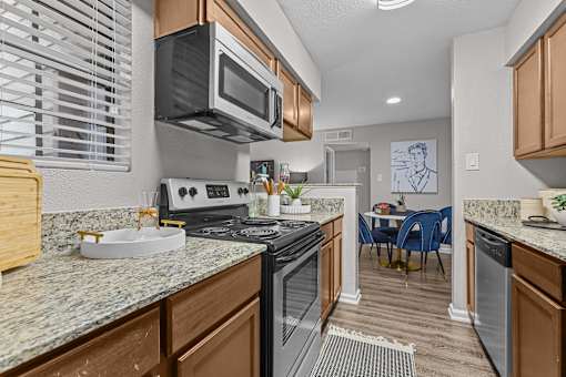 A kitchen with a stove top oven and microwave.