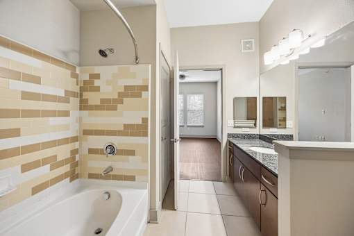 A bathroom with a tiled shower and a bathtub.