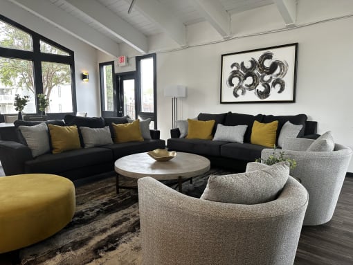 a living room with couches and chairs and a coffee table