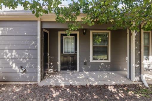 the front of a house with a porch and a door