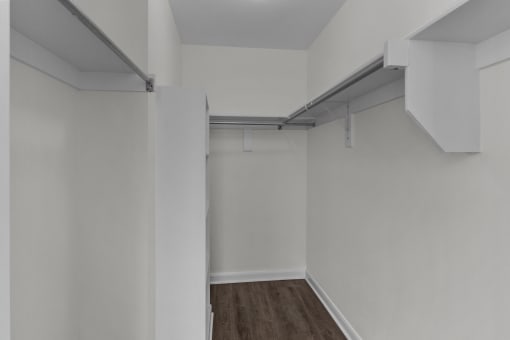 an empty room with white walls and a wood floor