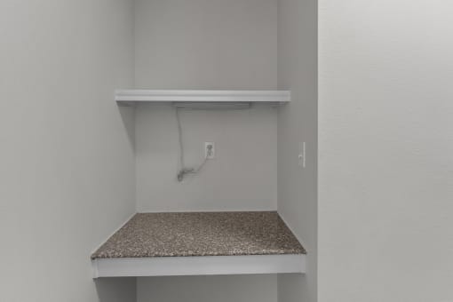 the closet in a bedroom of a house with an electrical outlet