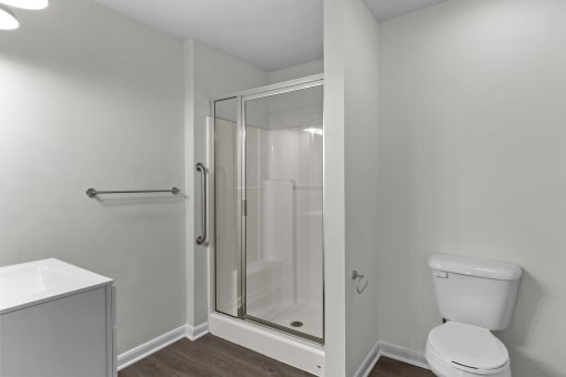 an empty bathroom with a shower and a toilet