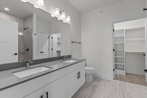 A bathroom with a white sink and a white toilet.