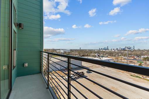 A balcony with a view of a city skyline.
