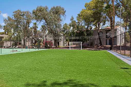 A soccer field with a goal post in the middle.