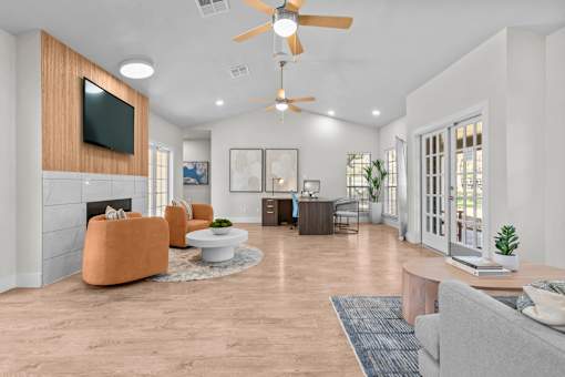 A living room with a television, a fireplace, and a ceiling fan.