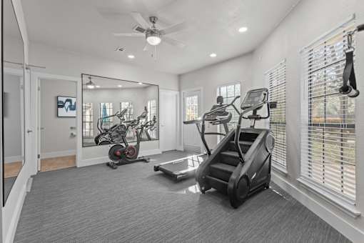 A spacious home gym with a variety of exercise equipment.