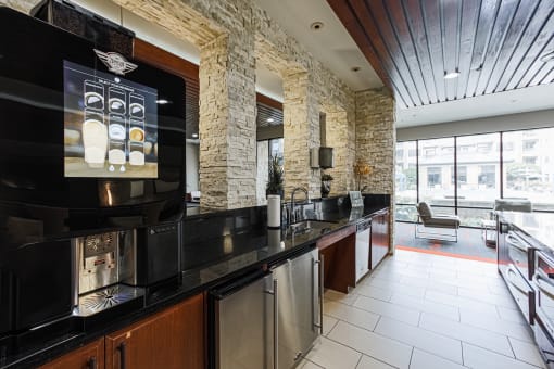 a kitchen with a long counter and a large screen tv on the wall